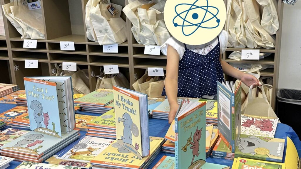 Girl selecting books for Summer Boost book bag.