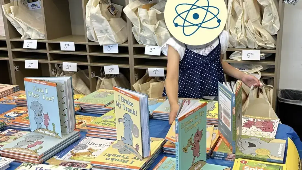 Girl selecting books for Summer Boost book bag.