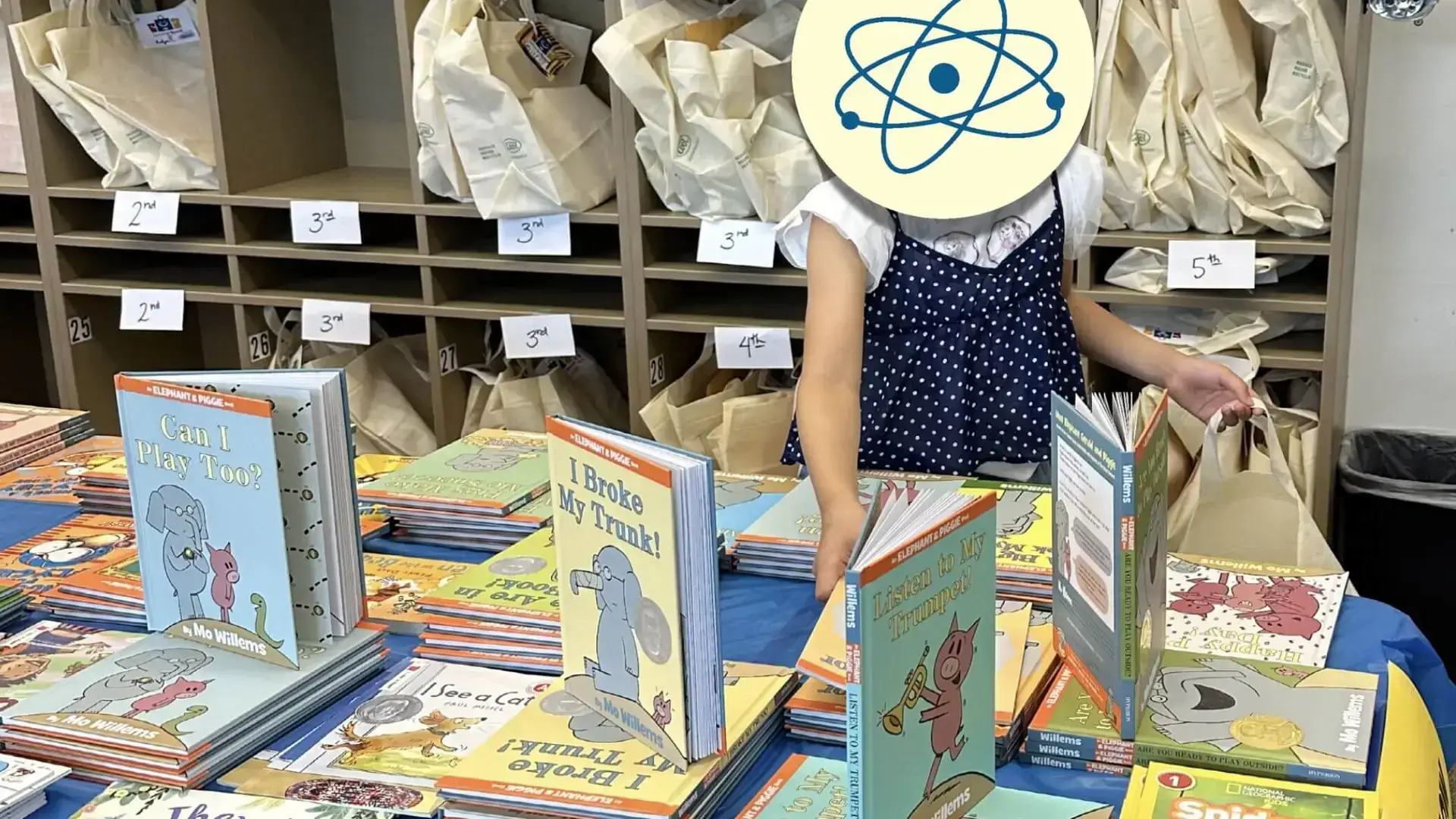 Girl selecting books for Summer Boost book bag.